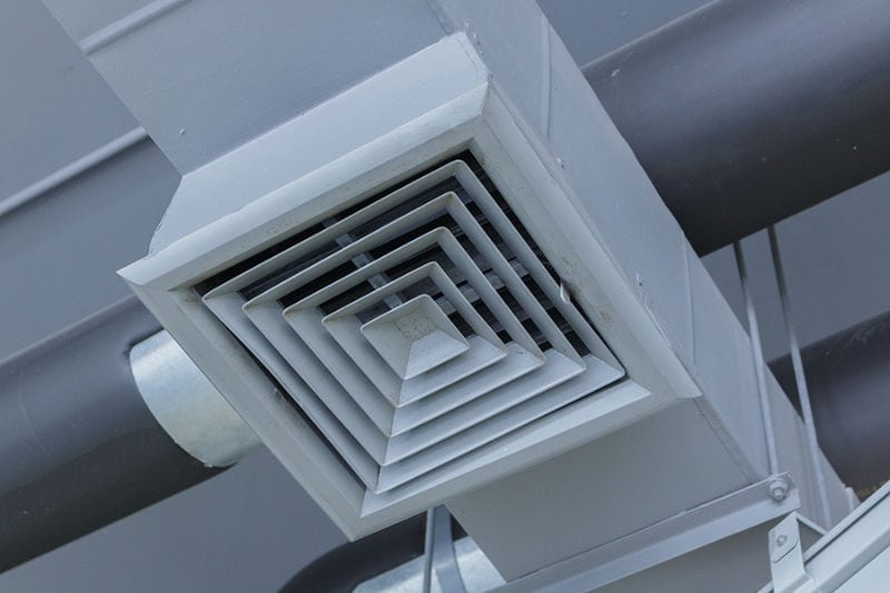 Close-up of ceiling vent for central air conditioner.