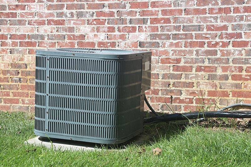 Air conditioner sitting outside home dealing with AC failure.