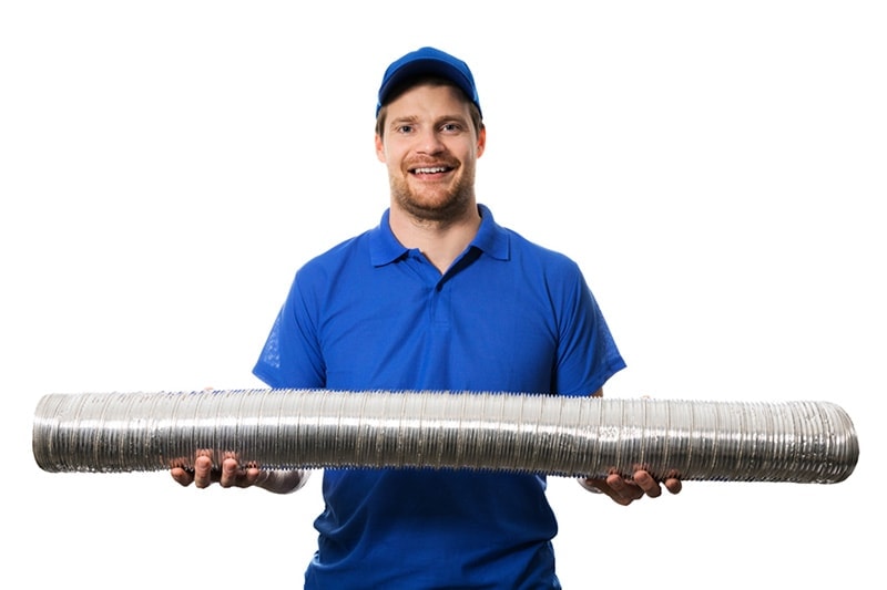 HVAC technician holding flexible ductwork to represent info on signs you need a new furnace.
