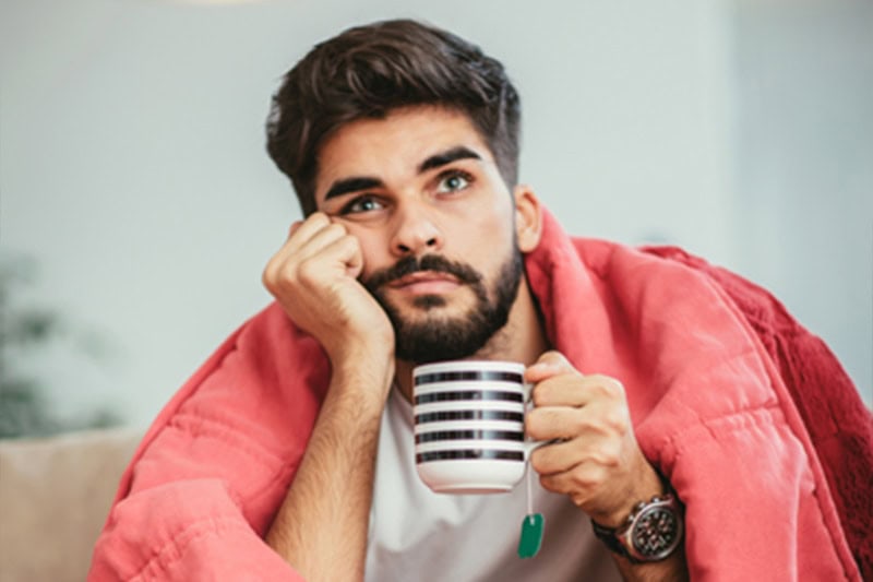 Guy sitting on the ground wondering why isn't my furnace heating my entire home?