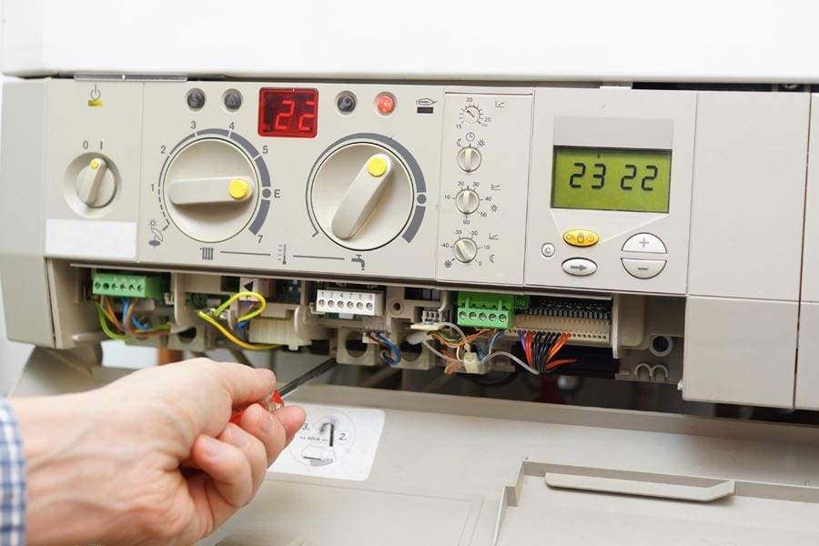 HVAC technician diagnosing whether or not a furnace can be repaired or needs to be replaced.