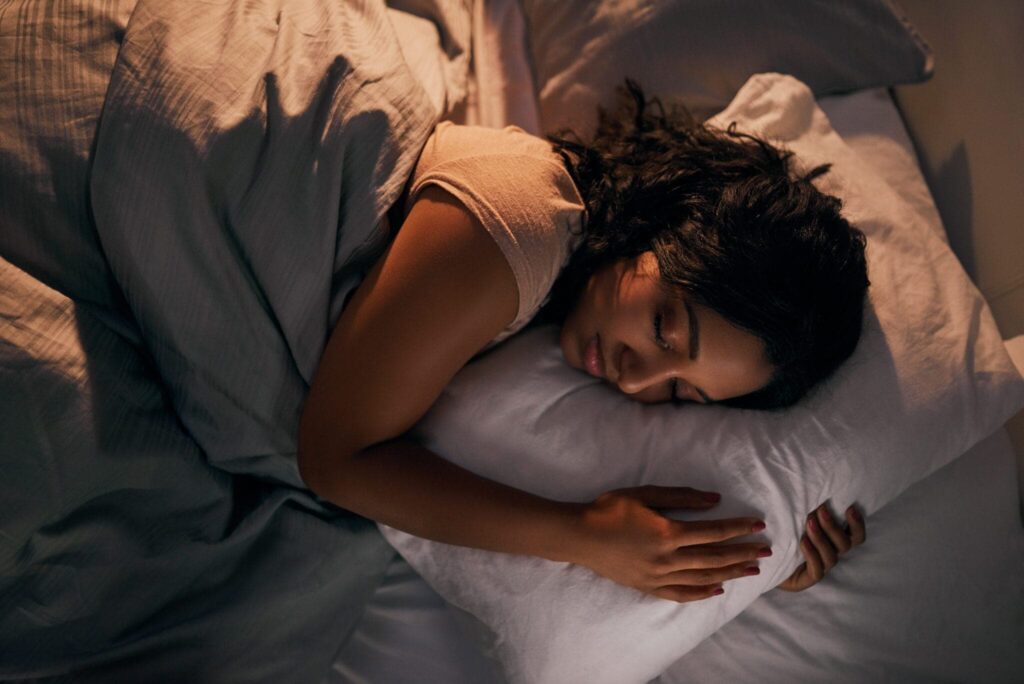 Young woman sleeping peacefully thanks to her HVAC system.