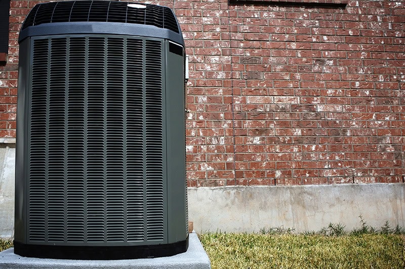 Heat pump sitting outside home in Marlborough, MA.