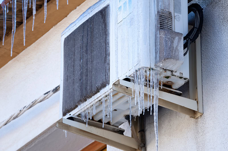 Frozen mounted heat pump outside home in Marlborough, Massachusetts.