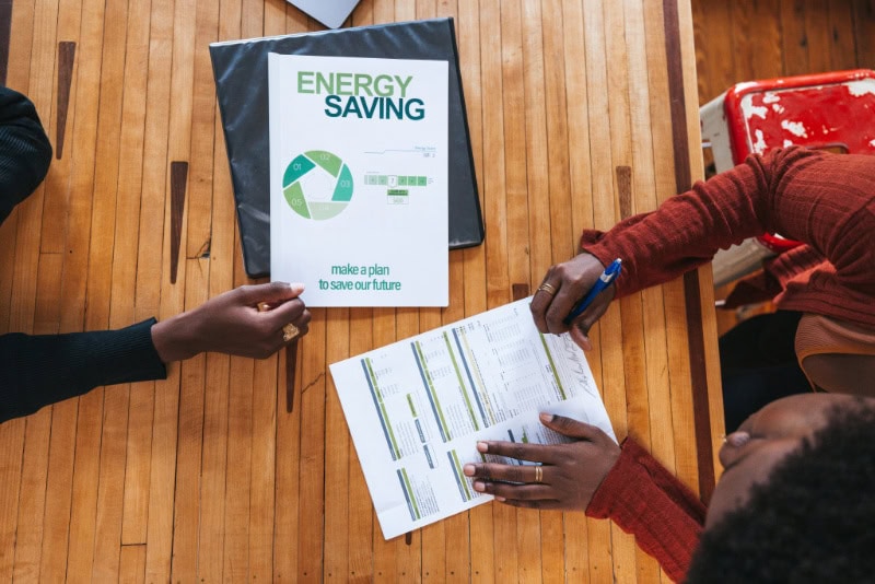Female homeowner filling out a tax credit form for a new geothermal heat pump installation in Hudson, Massachusetts.