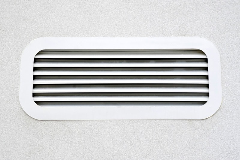 Vent on wall to represent information on air scrubbers and better indoor air quality.