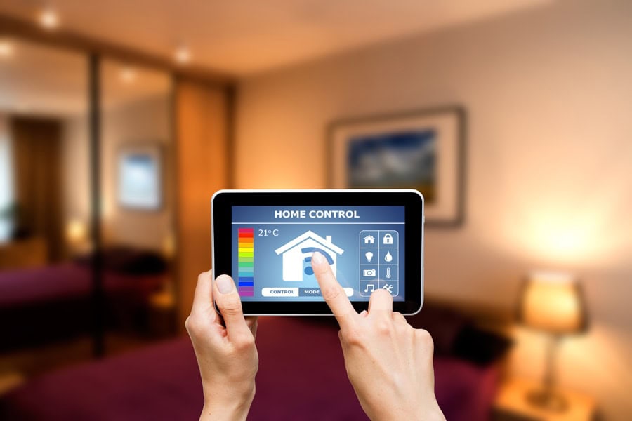 Homeowner holding a programmable thermostat.