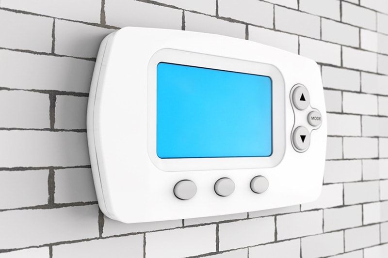 Thermostat mounted to wall in Hudson, MA, home.