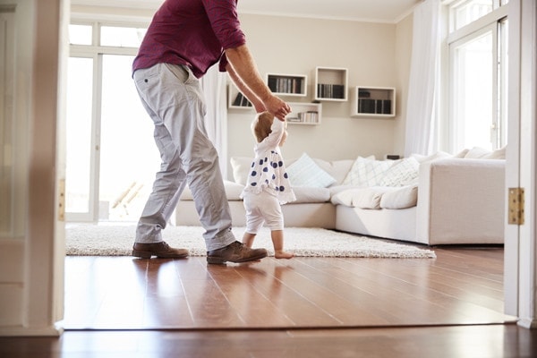 Father teaching his daughter how to walk.
