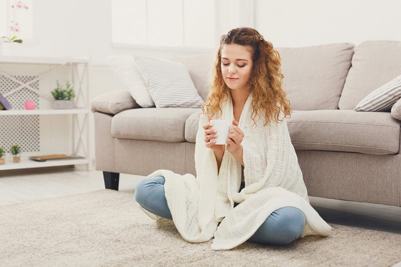 Cozy girl indoors with a cup of tea